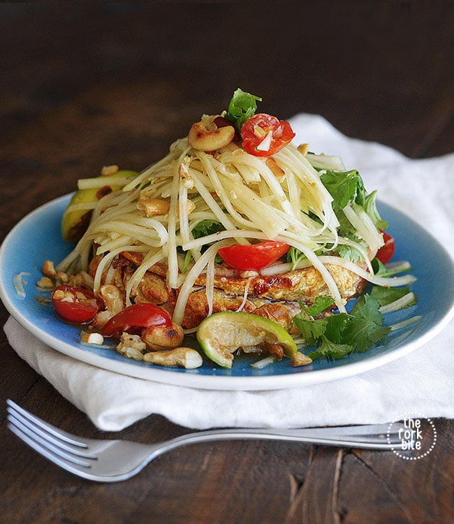 A refreshing and flavorful salad that's full of exotic spicy kick. This Thai Green Papaya Salad can include chopped peanuts, cilantro, tomatoes, and sliced green beans