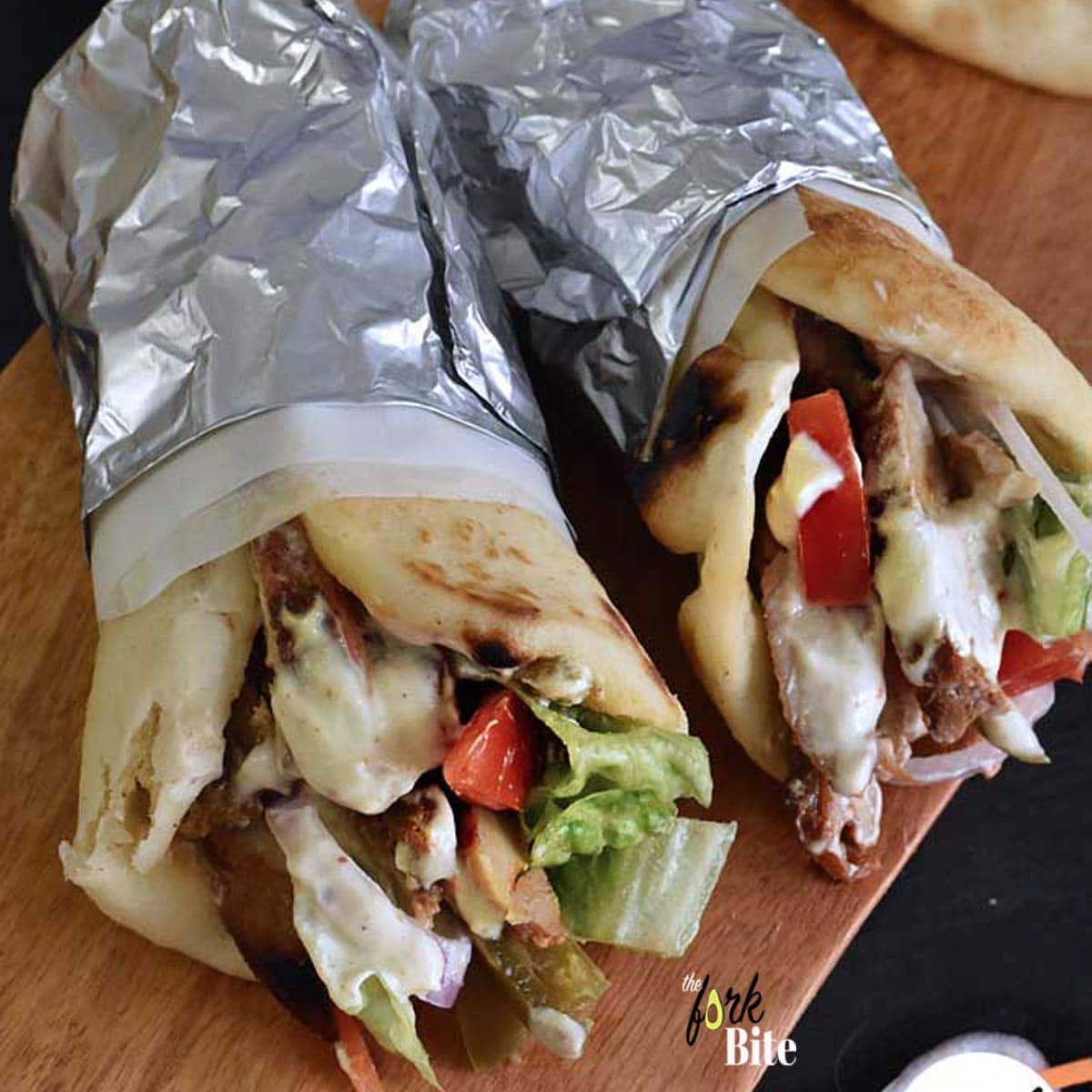 This Chicken Shawarma wrap is so tender, smokey and flavorful. Marinated in spices and roasted to perfection. Wrapped in a warm flatbread and top with garlic sauce or yogurt sauce, and crispy lettuce.