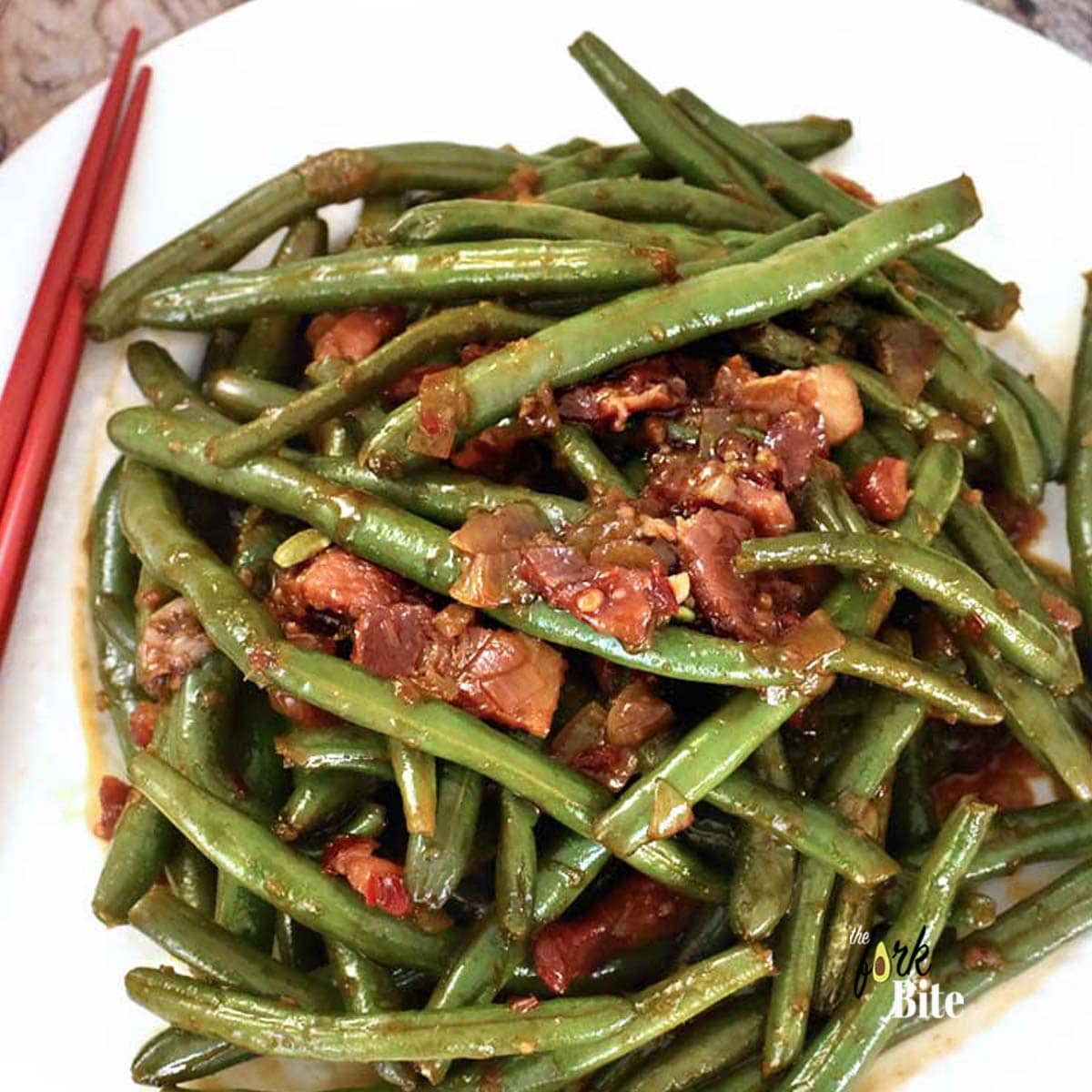 These Stir Fry Green Beans are so easy to make and so addictively yum. Loaded with chilies, crispy bacon, and garlic which is a great takeout fakeout.