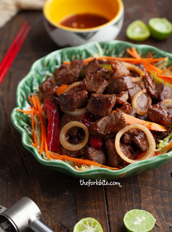 This Vietnamese Shaking Beef or Bo Luc Lac is super easy to make with a tender, flavorful taste of beef seared in a hot wok. Drizzling the greens in a light vinaigrette and top it with beef, the veggies wilt slightly and the beef juices and vinaigrette blend together into a tangy sauce that’s perfect over brown/white rice.