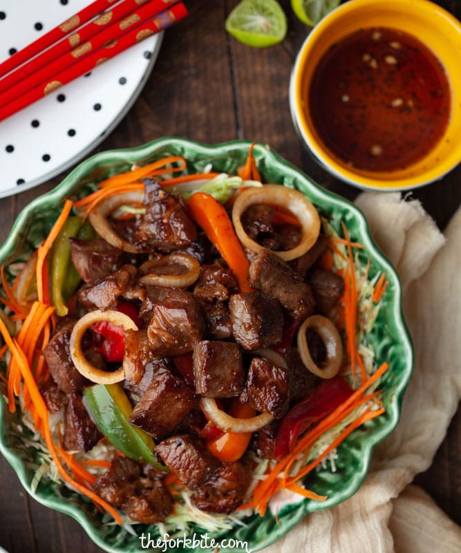 This Vietnamese Shaking Beef or Bo Luc Lac is super easy to make with a tender, flavorful taste of beef seared in a hot wok. Drizzling the greens in a light vinaigrette and top it with beef, the veggies wilt slightly and the beef juices and vinaigrette blend together into a tangy sauce that’s perfect over brown/white rice.