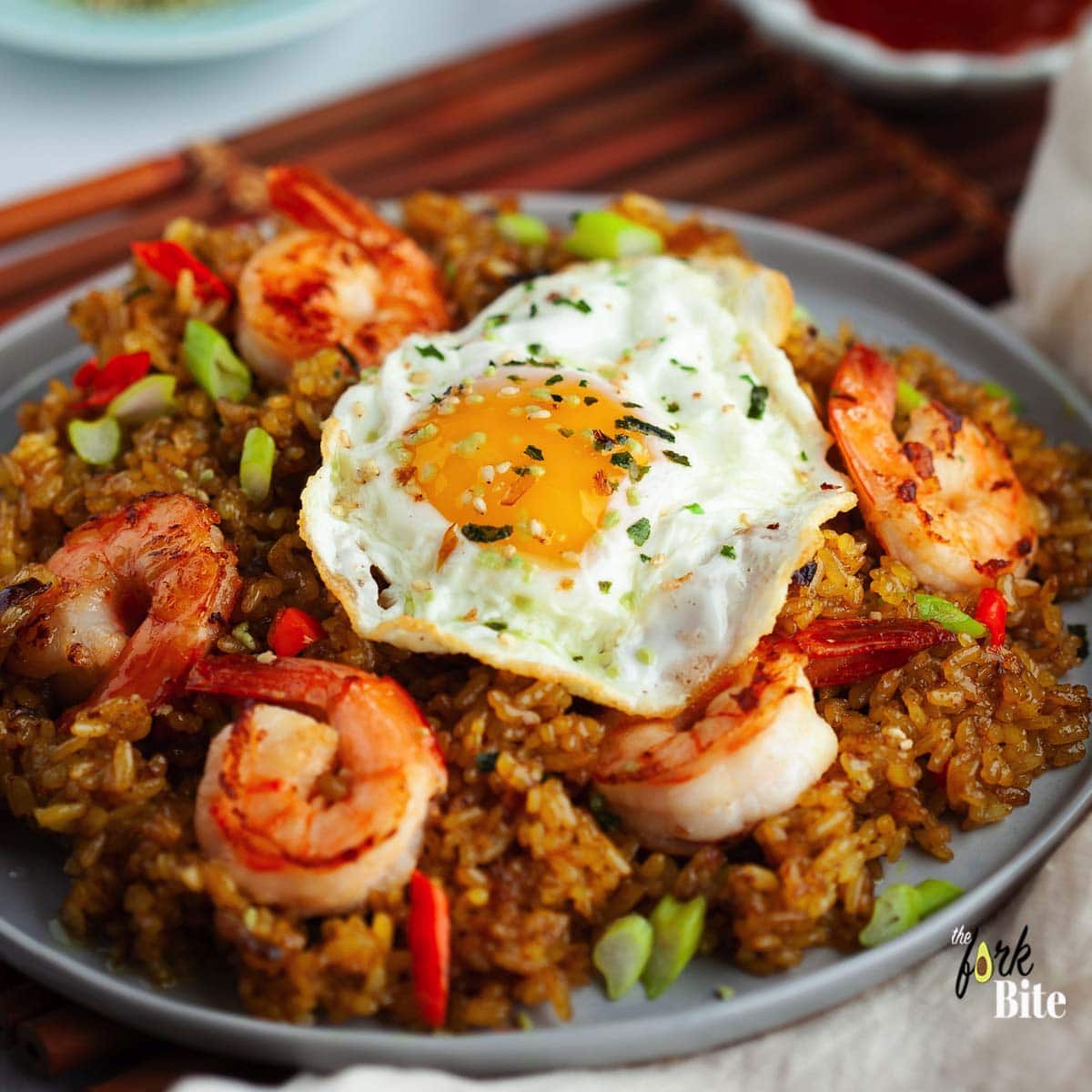 This Nasi Goreng or Indonesian fried rice with shrimp is one of my favorite fried rice recipes that packs a punch of sweet, spicy and savory flavors your family will love. Great use for leftover rice and ready in 15 minutes.