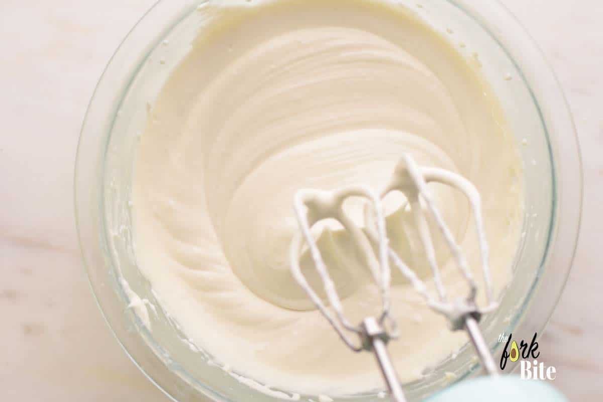 In a separate bowl, add the whipping cream and whisk until it reaches into a medium-peak consistency. How to check it? Just lift up the whisk attachment and the peaks should tip over a bit while holding their shape but have a softened texture.
