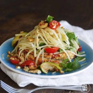 A refreshing and flavorful salad that's full of exotic spicy kick. This Thai Green Papaya Salad can include chopped peanuts, cilantro, tomatoes, and sliced green beans