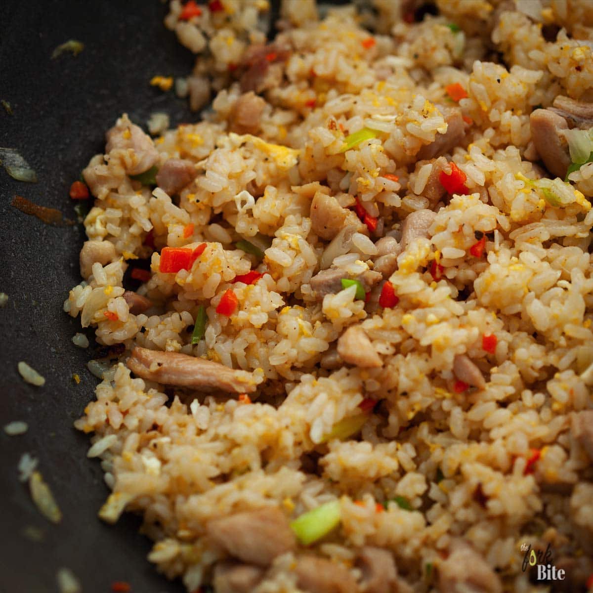 I tried and tested this trick and my fried rice worked perfectly fine. All you have to do is spread out the rice on a plate or tray while it's hot. Give it some time for its surface moisture to evaporate, and you can use it to make some excellent fried rice.