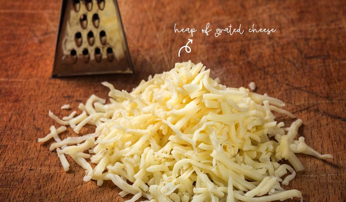 Store-bought grated cheese varieties have added preservatives like natamycin and anti-caking agents like cellulose to keep the shreds from clumping up together inside the package.