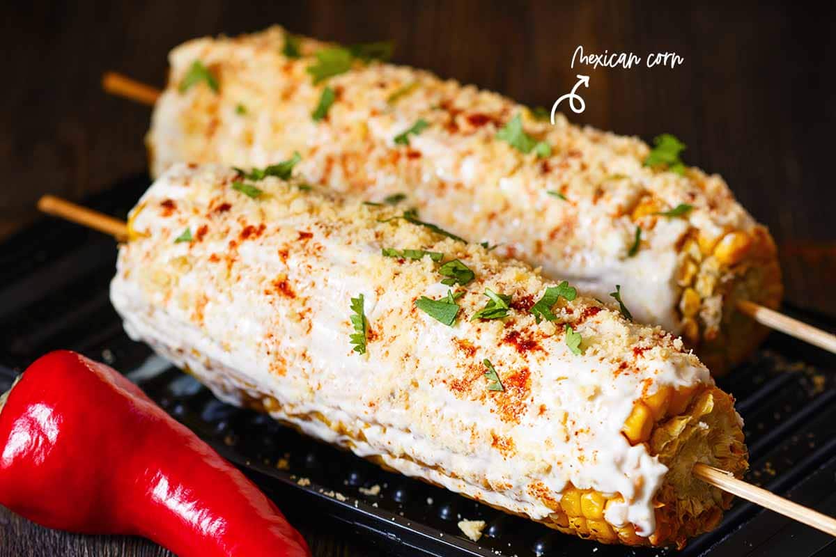 Mayonnaise, chili powder, cilantro, and cotija cheese wrapped around my Mexican corn. They looked pretty beside the big-serving bowl of mac and cheese. And when we had them with the mac and cheese, they were terrific!