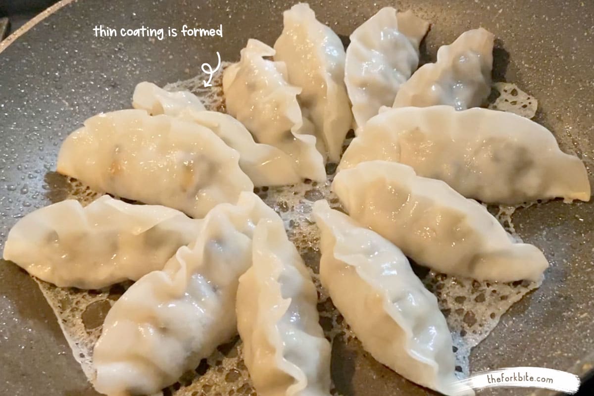 let the slurry cook for another one or two minutes, it will start off as a thick paste but as it continues to cook the paste will evaporate and becomes a thin coating until the potstickers’ bottoms get crispy.