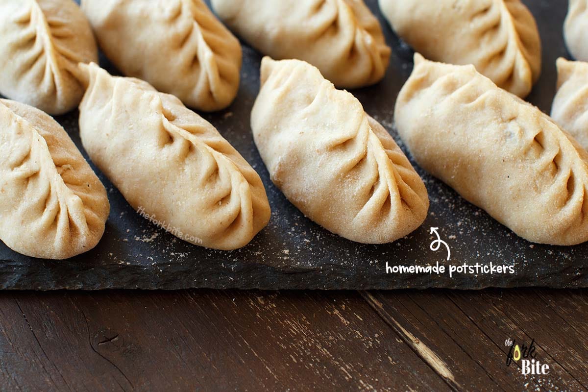 Lay the dumplings out onto some parchment-lined baking sheets and freeze them until they're hard. Then you can put them all together into one zip-lock plastic bag and place them in the freezer.