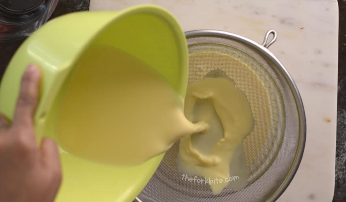 Pass the loose custard mixture through a fine sieve. This will eliminate any egg curds or lumps from tempering the eggs earlier. After straining, let the mixture cool down for about 12 minutes. 
