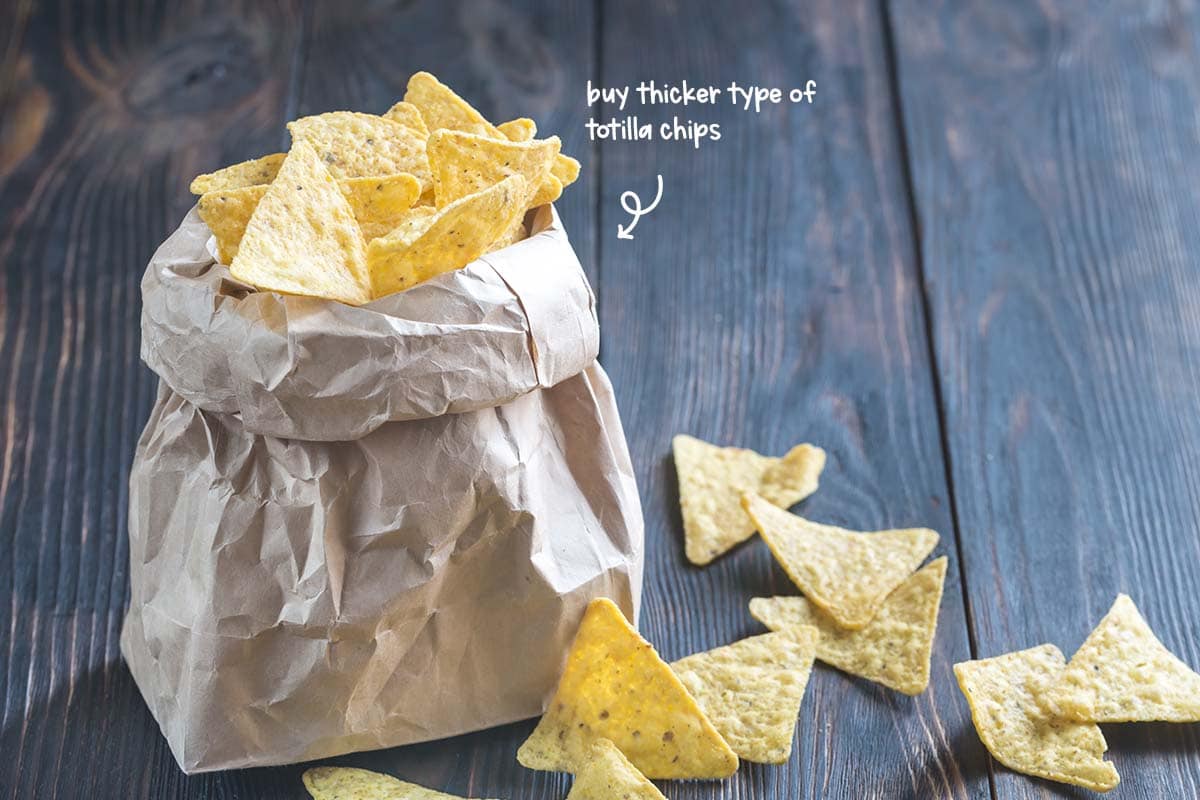 Buy the thicker, more sturdy type of tortilla chips that will perform their load-bearing task better. Don’t go for the thickest kind, as they feel as if they are ripping the roof of your mouth asunder.