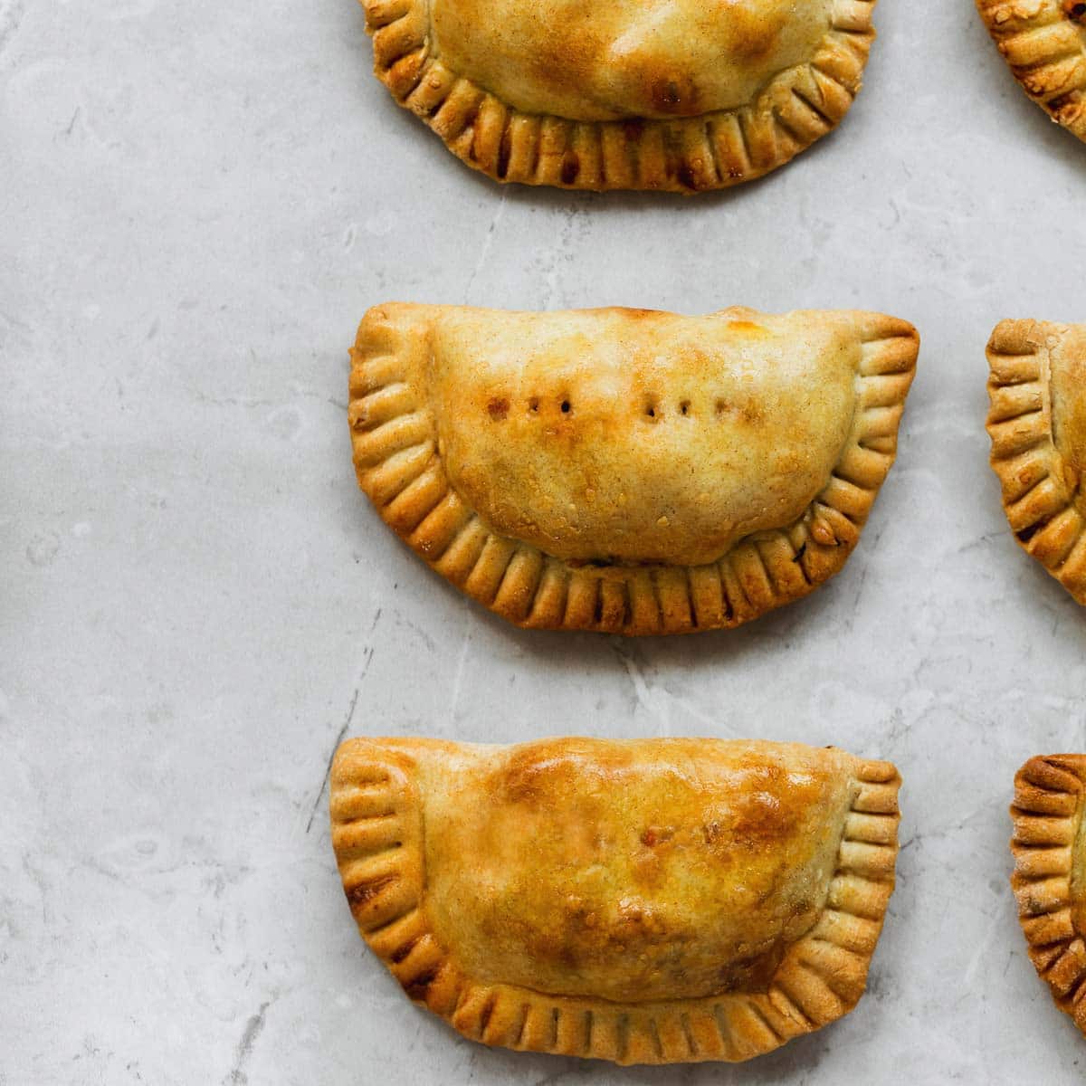 Empanadas can be successfully reheated from various conditions. You might want to warm them from frozen, or straight out of the refrigerator. Or after they’ve been standing around for a little while at room temperature.