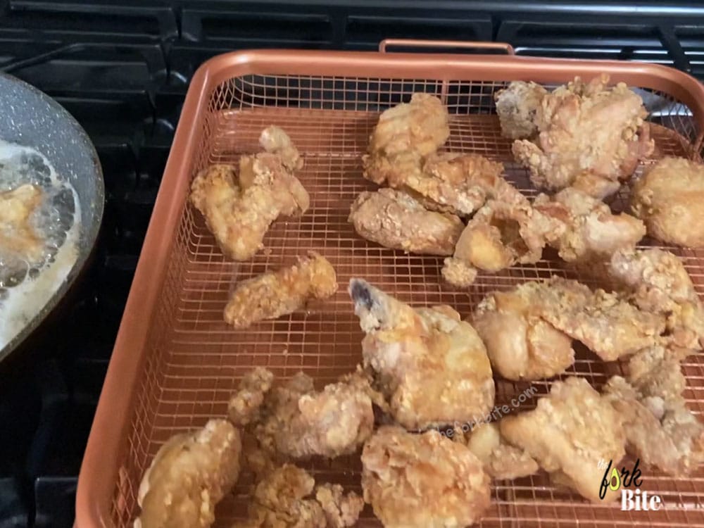 Now, you can put the chicken pieces into the hot oil. Don’t overcrowd the wok. Let the chicken cook for about 2-3 minutes, move them around so they are not sticking to each other. Take the chicken off the heat and let them drain and dry.