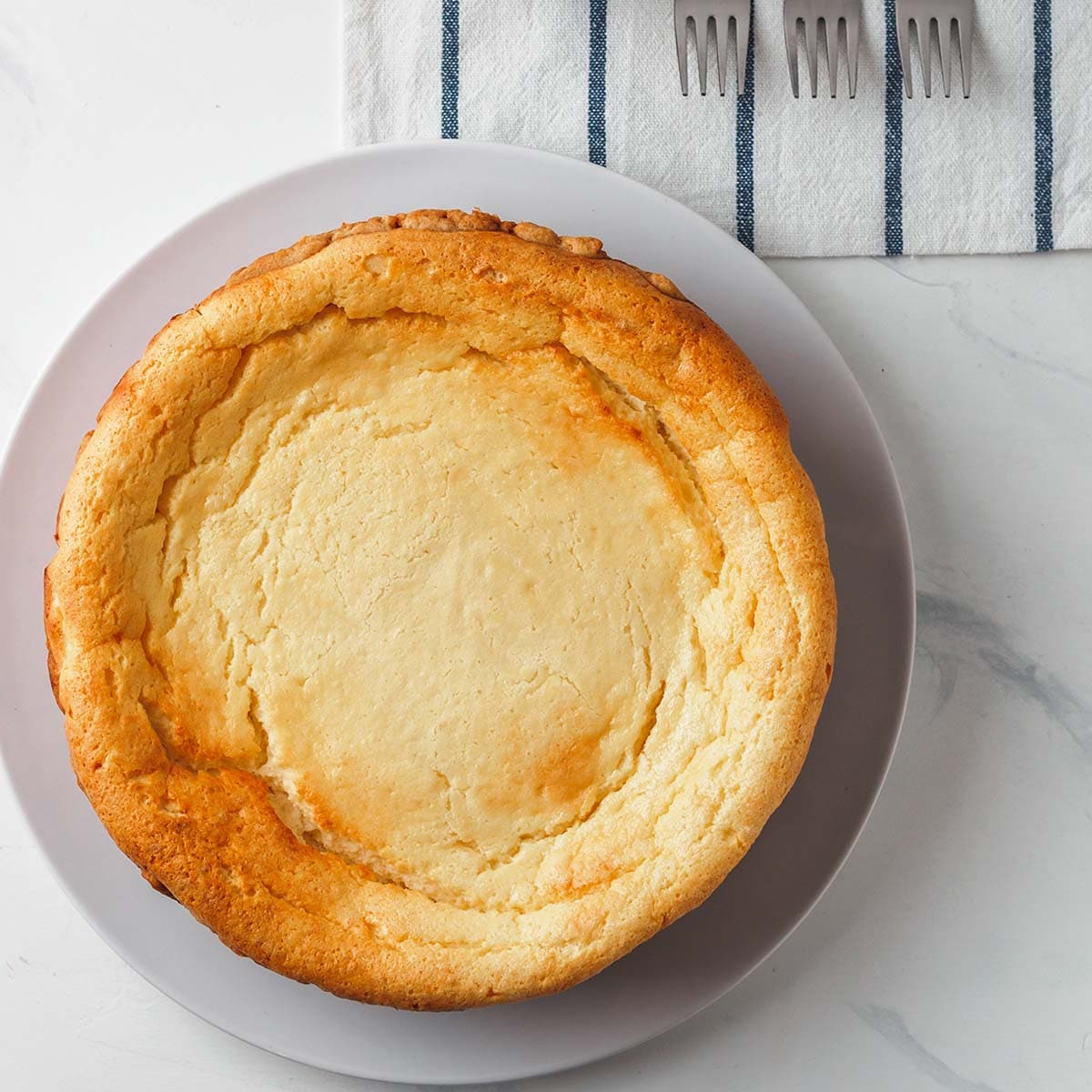 If a cheesecake dries out too much as it bakes, this also can cause cracking. To negate this, place a pan of water on another rack directly below the cheesecake.