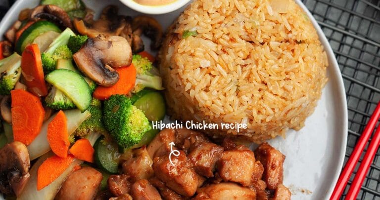 This copycat Hibachi Chicken recipe is made of savory chicken bites with sautéed vegetables, served over fried rice and topped with yum yum sauce.