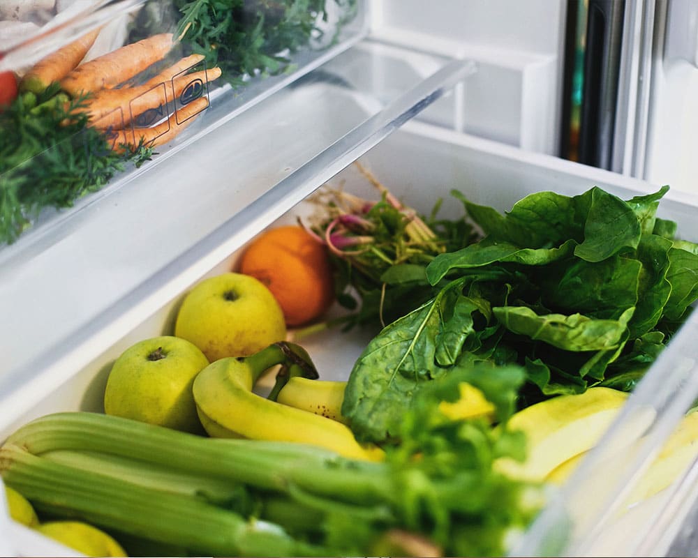 A crisper drawer is a closed environment that can keep a small amount of moisture. It does seem to be an ideal place for veggies and fruits.