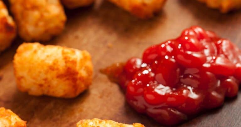 Tater tots meld together because of the combination of proteins and wet starches. When these two sticky ingredients increasingly touch each other, the sticker and chewier the tater tots become.