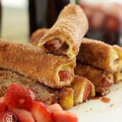 These french toast roll ups taste like a doughnut! Quick and easy to make, a perfect treat for breakfast or brunch. They are filled with Nutella and strawberry rolled in cinnamon sugar.