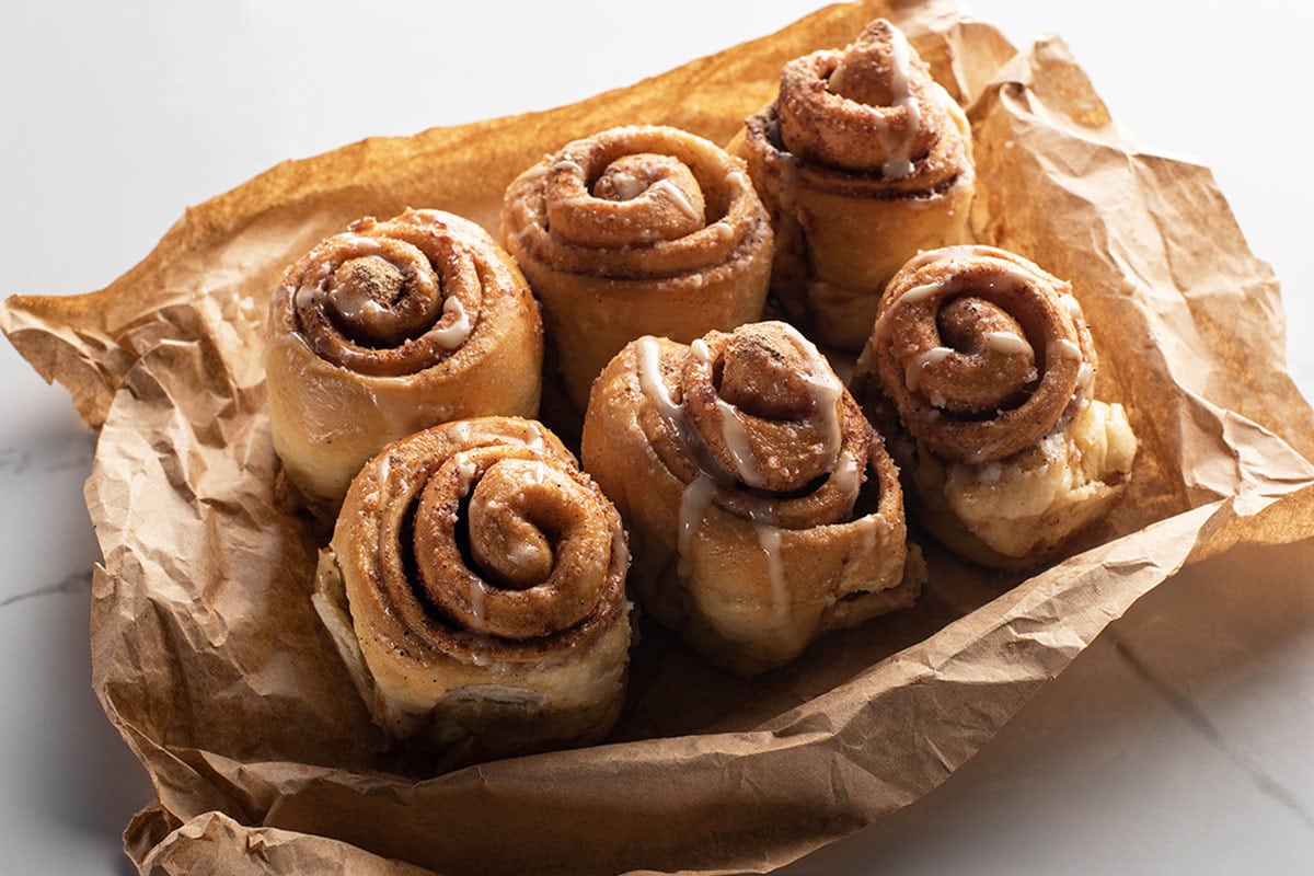 If you've made a big batch of cinnamon rolls then the oven is your best option for reheating. If reheating from frozen, I find it's best to allow them time to thaw in the fridge.