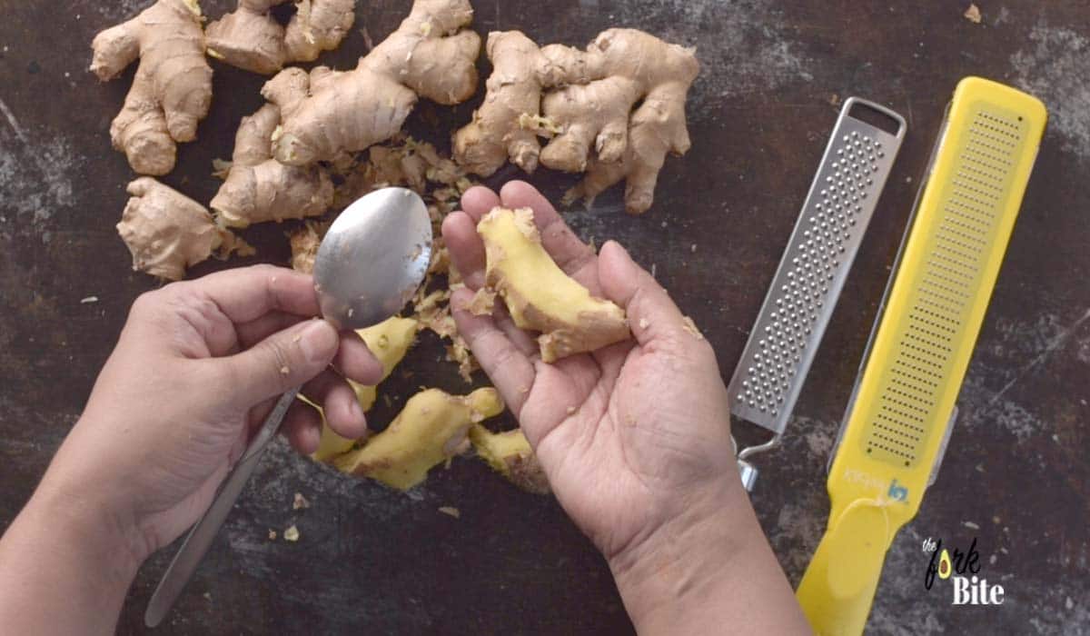 A trick that I have learned is to peel ginger with a spoon. You only have to scrape the edge of the spoon across the surface of the ginger, and the skin rubs off quite easily.