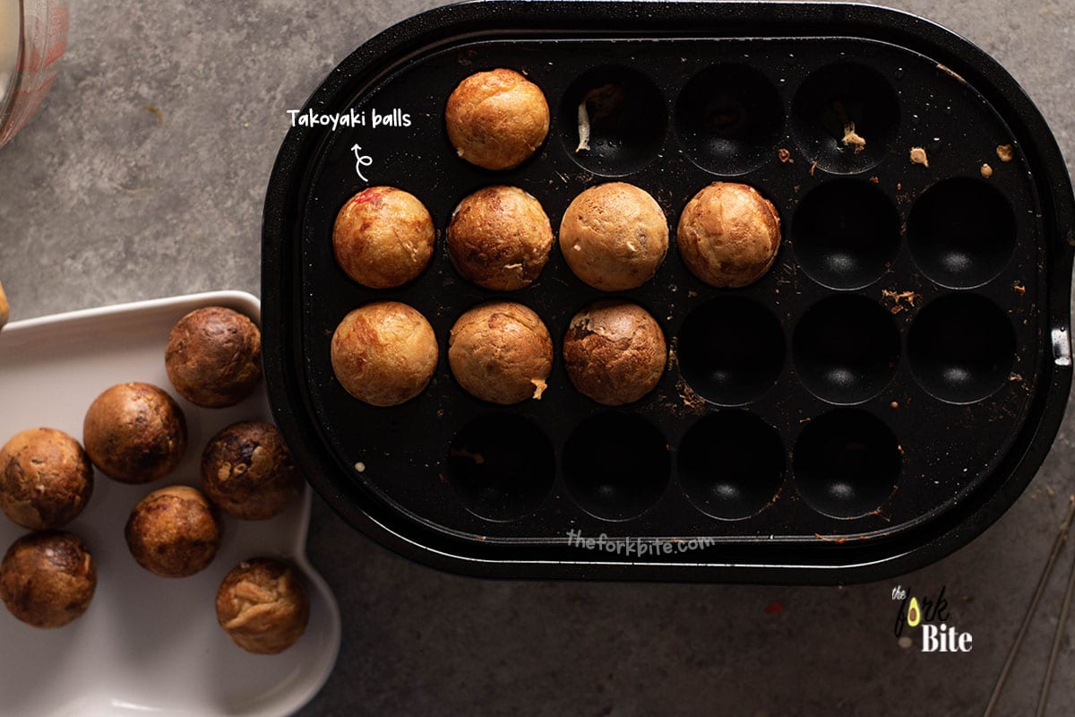 Take skewers and turn the Takoyaki at least 90 degrees. If you find that you are having a hard time doing this, allow them to cook a little longer and then try to turn again.