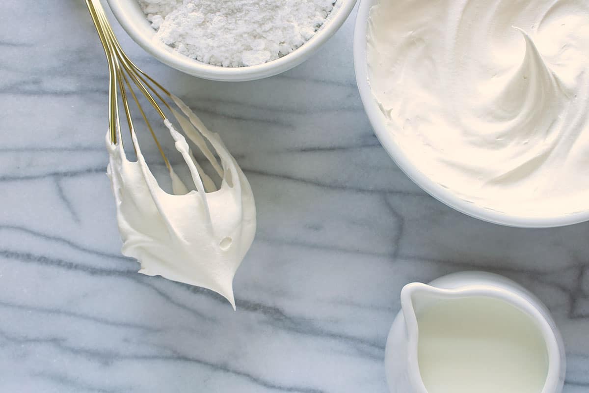 Put the pre-softened cream cheese, powdered sugar, and vanilla into a large size mixing bowl and mix gently until it becomes light and creamy.
