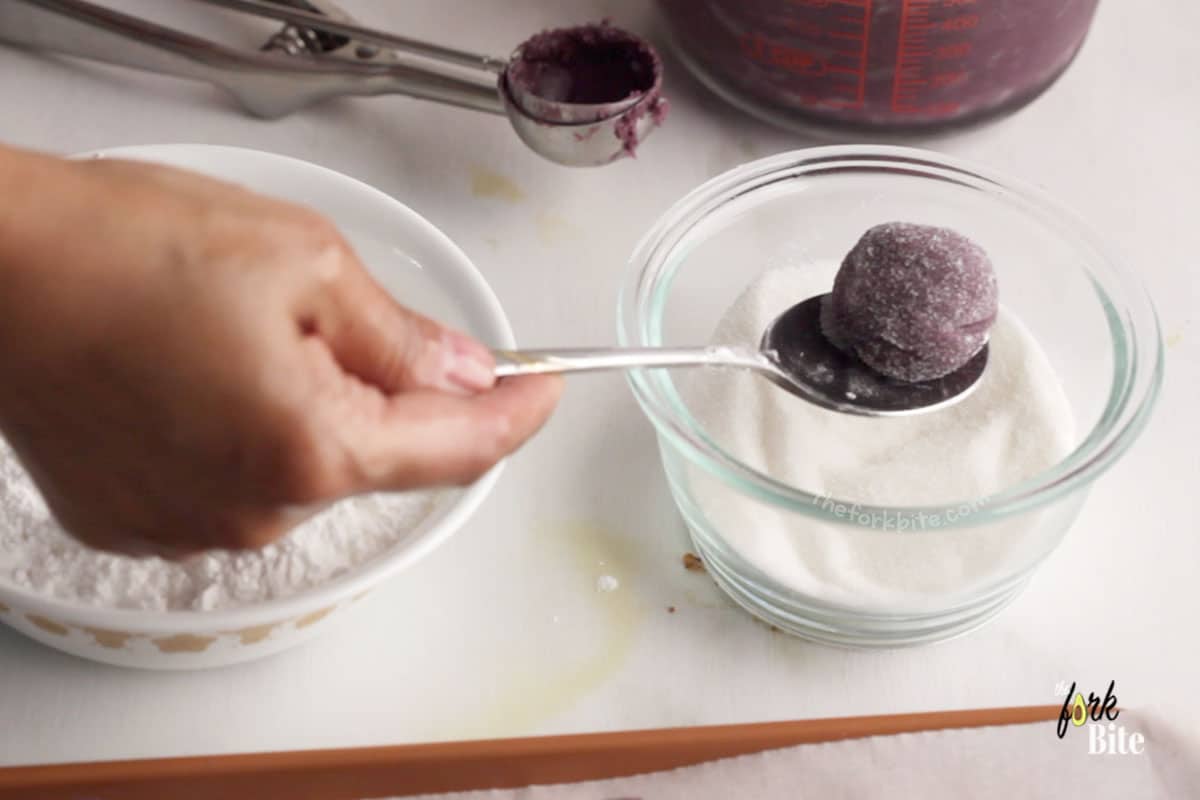 Roll each ball in granulated sugar first and then drop them into the powdered sugar bowl and coat it well.