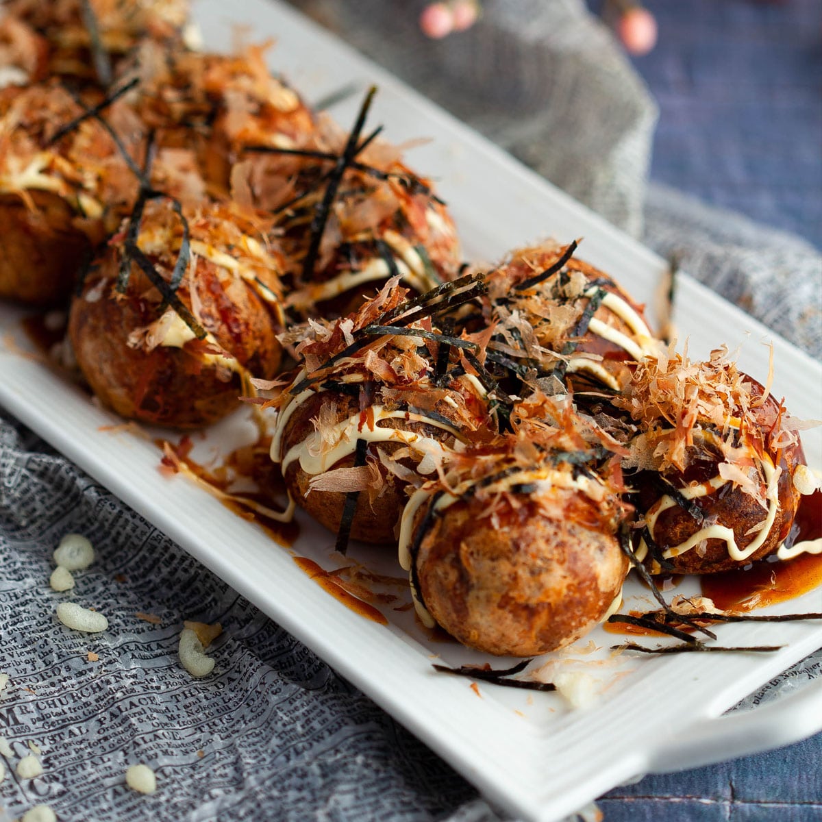 Takoyaki balls are fluffy, rich-tasting dough balls covered in a savory and delicious Takoyaki sauce.