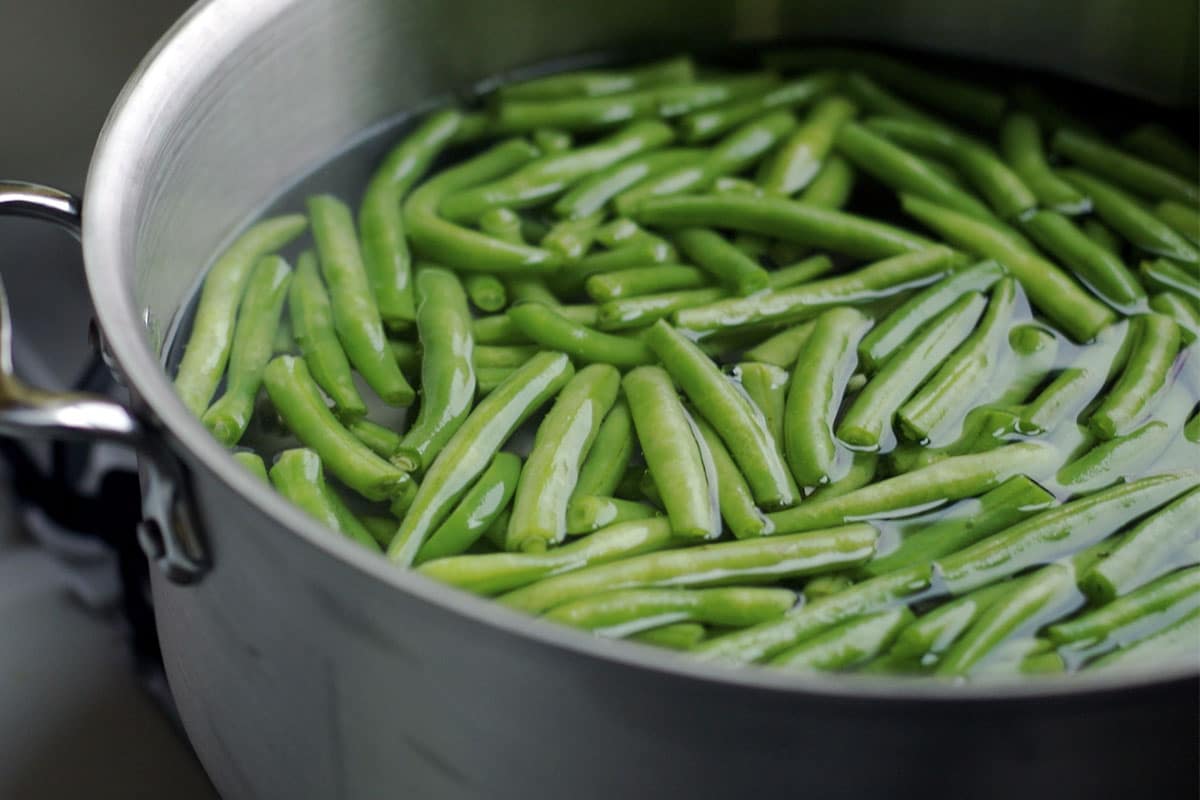 When you blanch green beans, you will end up with wonderfully bright green colored beans. They look even more vibrantly colored than they did in their raw state.