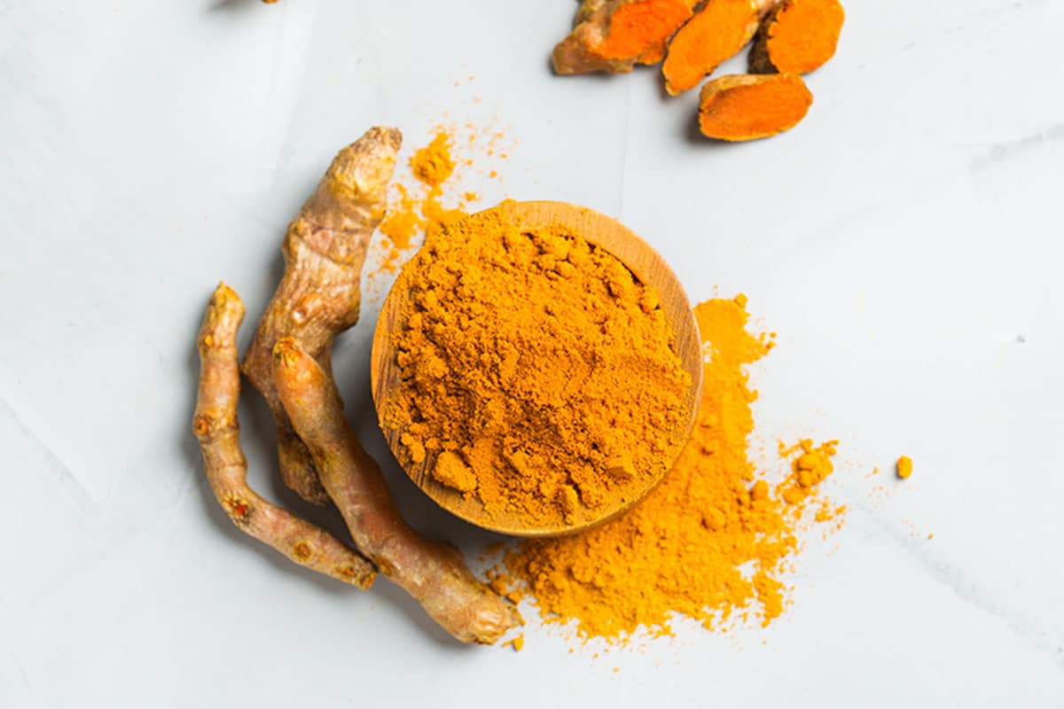 You dry turmeric by peeling or scraping the skin off, boiling the rhizomes, then drying them and keeping the pieces whole, or grinding them down into a fine powder.