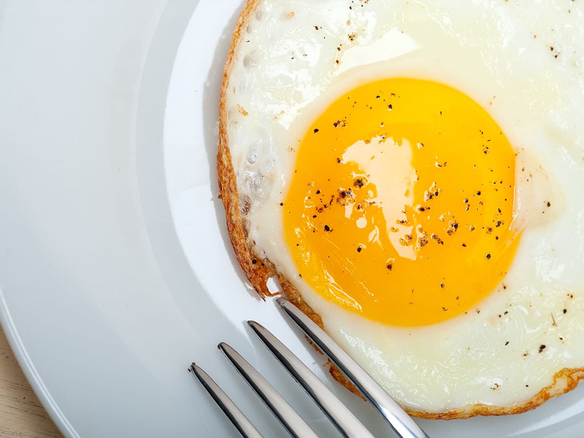 Here is a little trick that avoids flipping and the danger of breaking that precious yolk in the process. Instead of flipping, allow the eggs to steam.