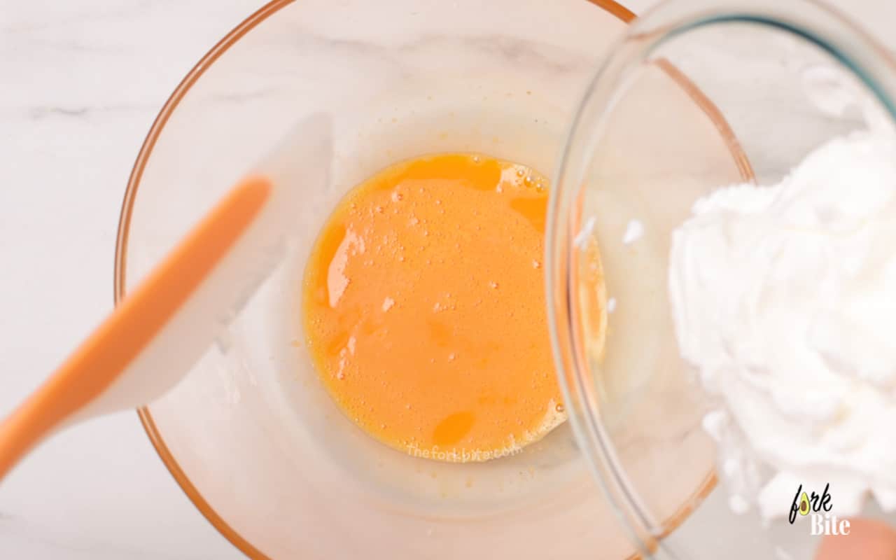 Once those medium peaks have developed, fold in your light egg whites into the yolks.