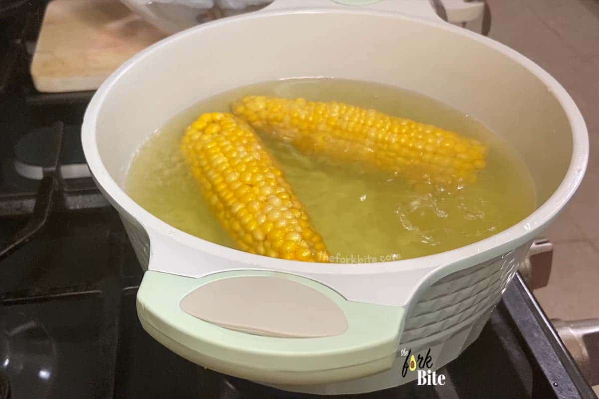 Fill a large pan with water, bring to the boil on your stovetop and carefully lower the cobs until they are fully immersed.
