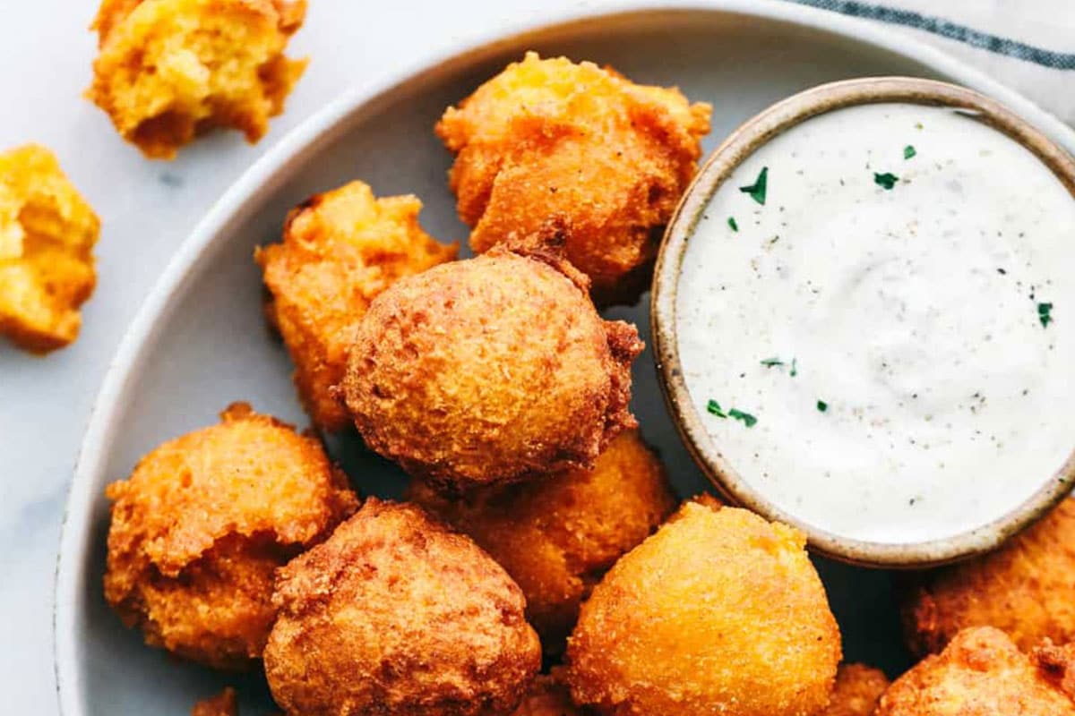 These little bite-sized pieces of heaven consist of a light, flakey cornmeal batter that is molded into small balls and deep-fried.