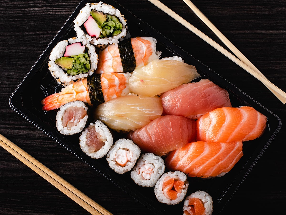 As long as you are using fresh or properly stored raw fish, it shouldn't be a problem. If you think about it, it's only like when the sushi chef creates those lovely little rice rolls with his or her hands.