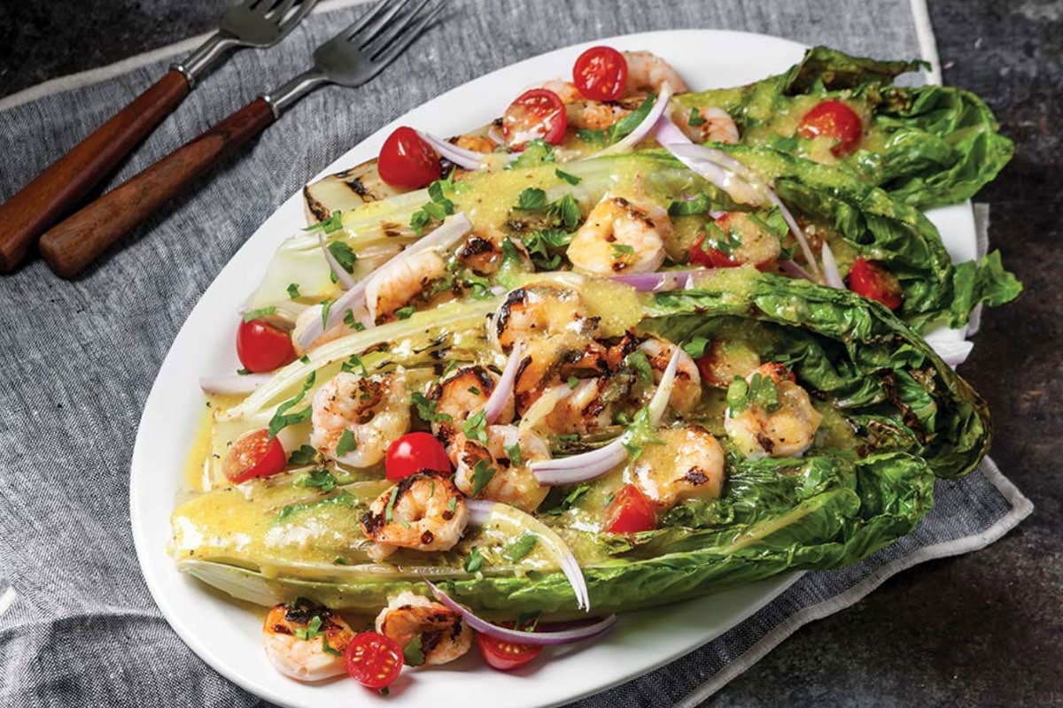 Served with a punchy dressing made from garlic, lemon juice, oil, and Romano cheese, these crunchy Romaine lettuce hearts sit so well beside Jambalaya; once you try this combo, you'll repeat it time and time again.