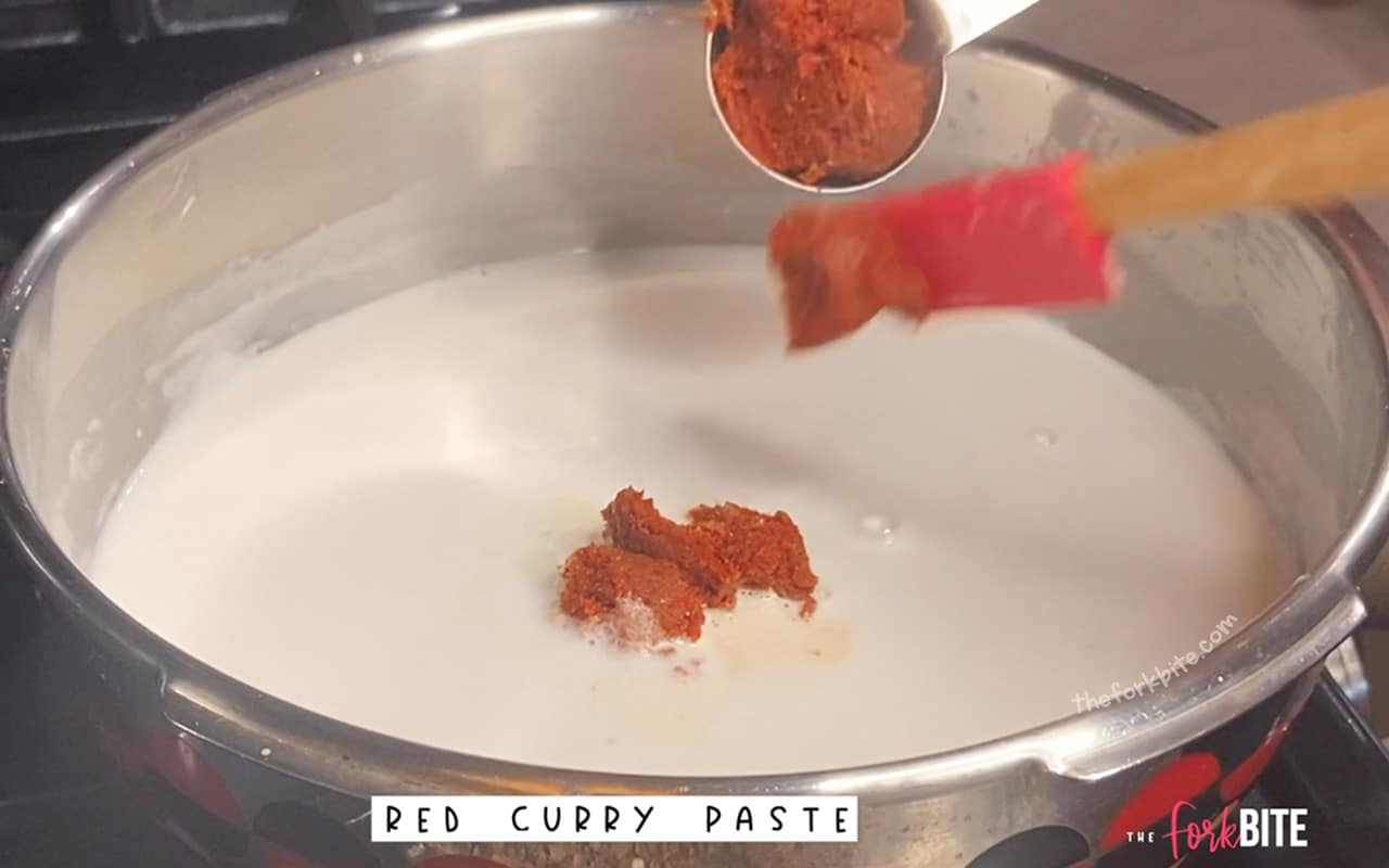 Add the red curry paste. Use a mesh strainer ladle and a spoon to help the paste breaks down or dissolves completely.