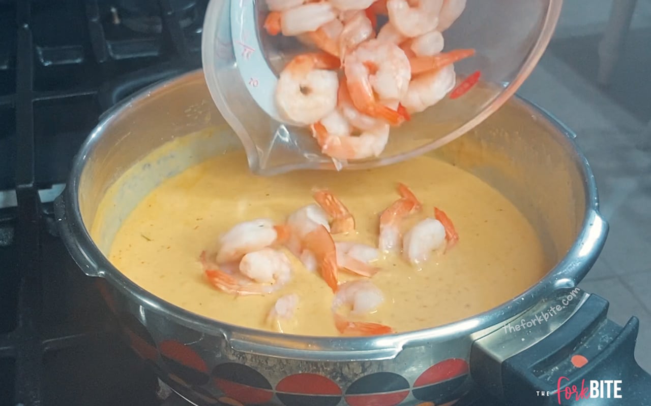 Now, you can add the shrimp. Place the lid on the pan and steam for up to a minute (if using cooked shrimps) or 2 minutes (for fresh shrimps) on medium heat.