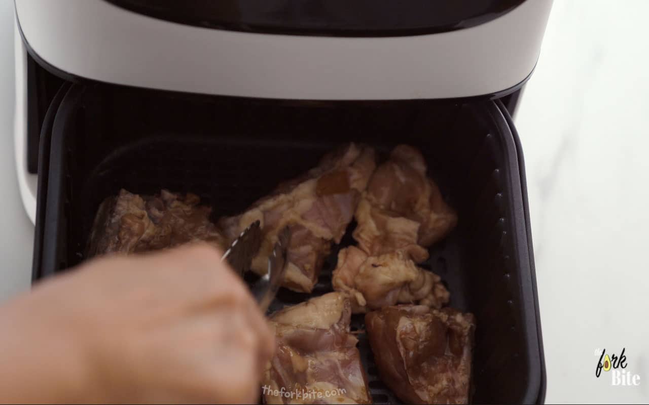 Transfer the marinated chicken into the air fryer basket. Cook for approximately 15 to 18 minutes.
