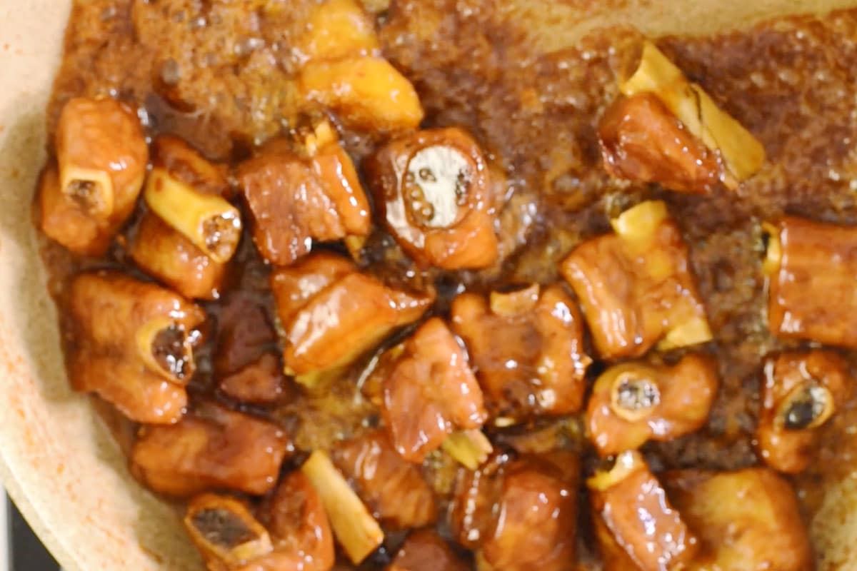 Uncover and cook in medium heat to reduce the sauce until it thickens and becomes sticky enough to coat the pork.
