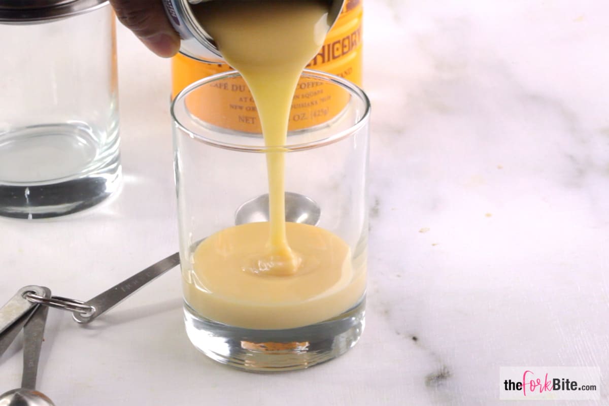 Add 2 tbsp Condensed milk in a heat-proof glass container. Remove the lids and the inner filter from the Phin.