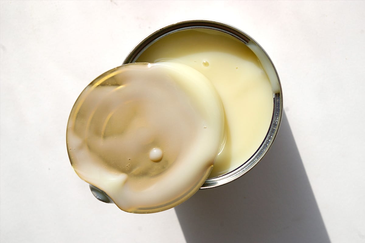 Condensed milk left in its original can, unopened, will be perfectly edible many months after its "best by" date as cans are the best way of packaging foodstuffs to keep them fresh and unspoiled for extended lengths time.