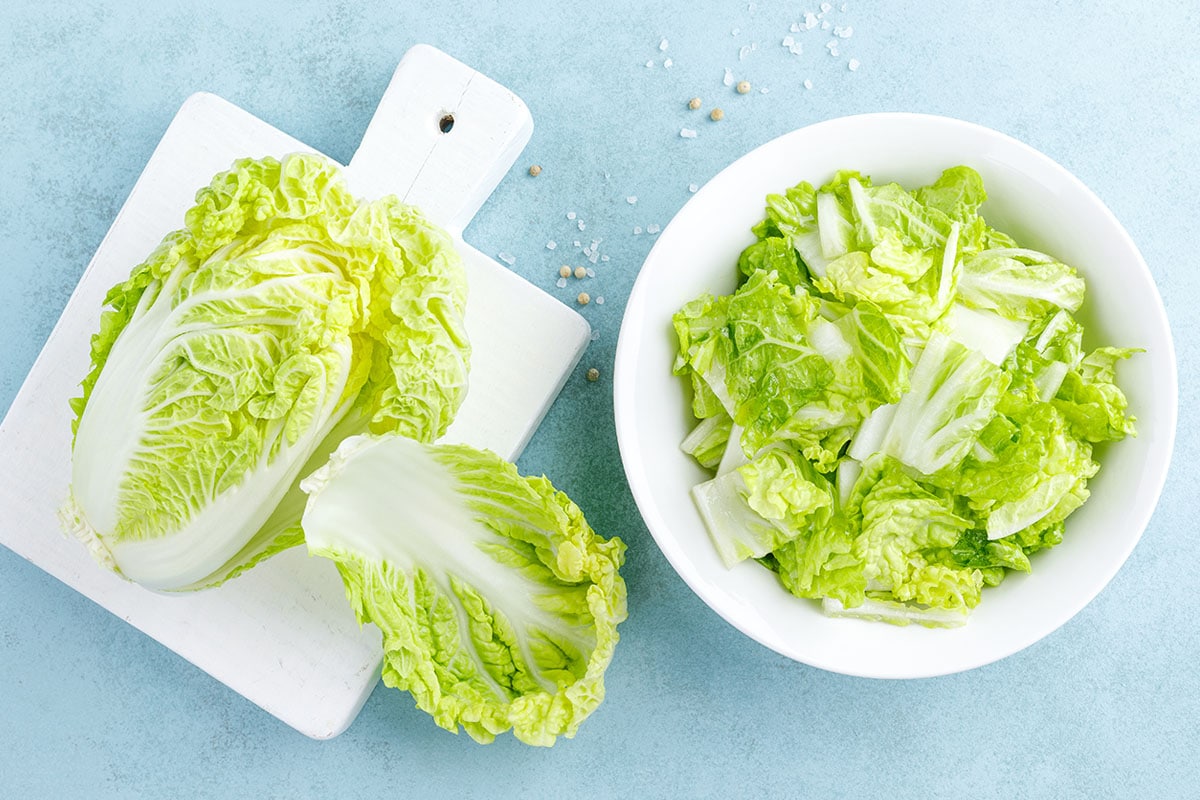 Napa cabbage is a green leafy vegetable that has tightly bunched white stalks. The leaves are clustered, hence, forming a head. Bok Choy, on the other hand, has no head. Flavor-wise, Napa cabbage is the milder of the two.