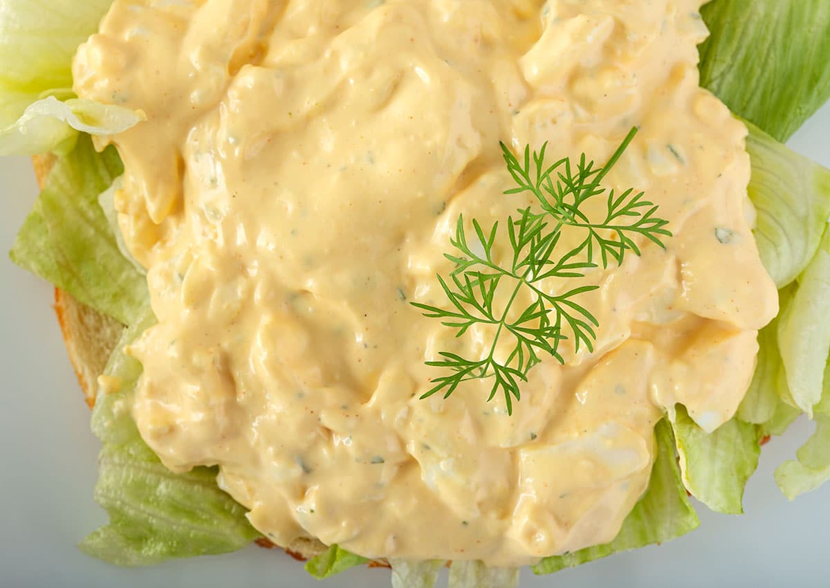 When you refrigerate egg salad, you should transfer it into an airtight container and place it towards the back of the fridge where the temperature is more constant. When stored in this way, it will last for anywhere between one and five days.