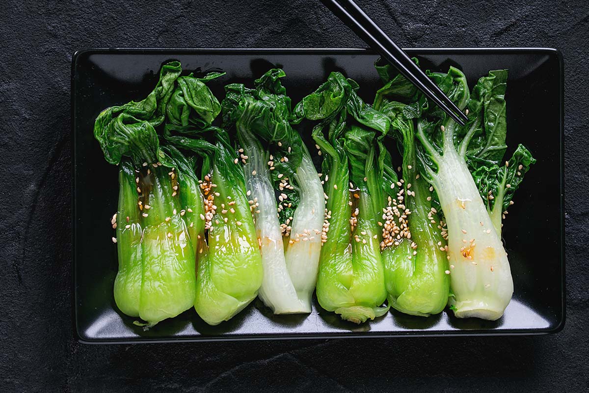 Bok choy tastes fresher and has a hint of grass, with a delicious, slightly peppery aftertaste. While the dark green leaves are tender and delicious, the white stalks are gorgeously crunchy.