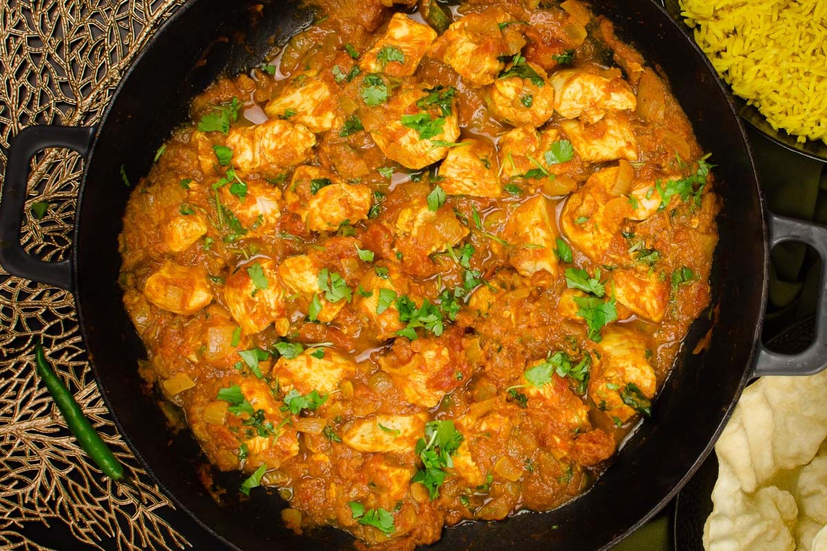 When making a Bhuna, the spices, including chili powder, cooling, and ginger, are fried in oil to enhance their flavor further. Meat is then added and cooked through before being served. There is no sauce.