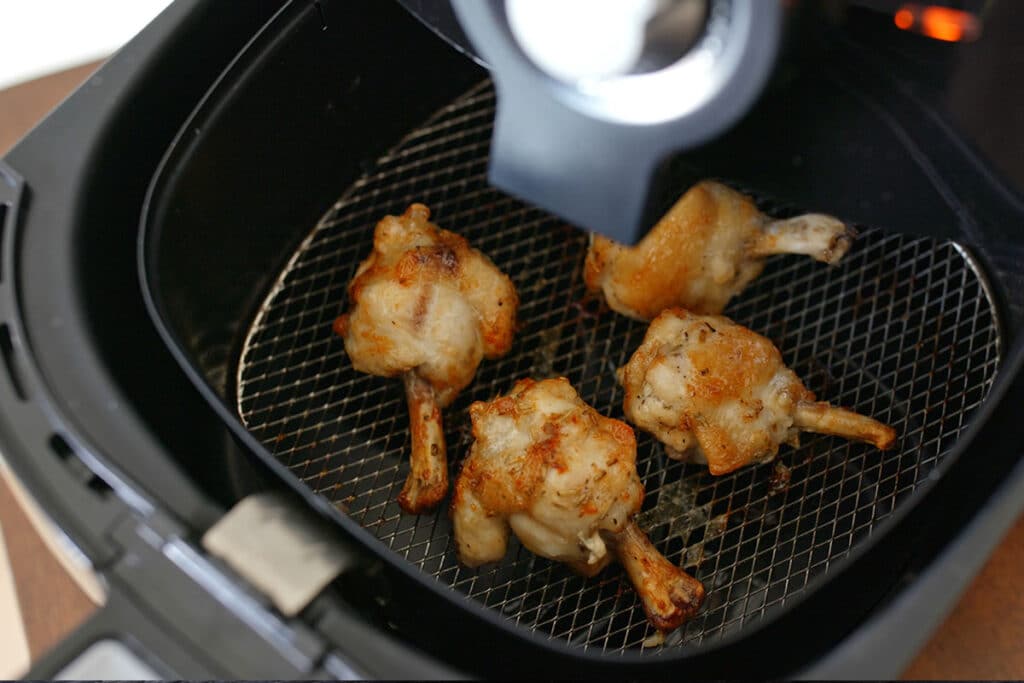 Preheat the air fryer at 375°F. Take the KFC chicken out of the fridge and leave it to come up to room temperature. Coat the chicken all over with cooking spray and transfer it into the air fryer basket.
