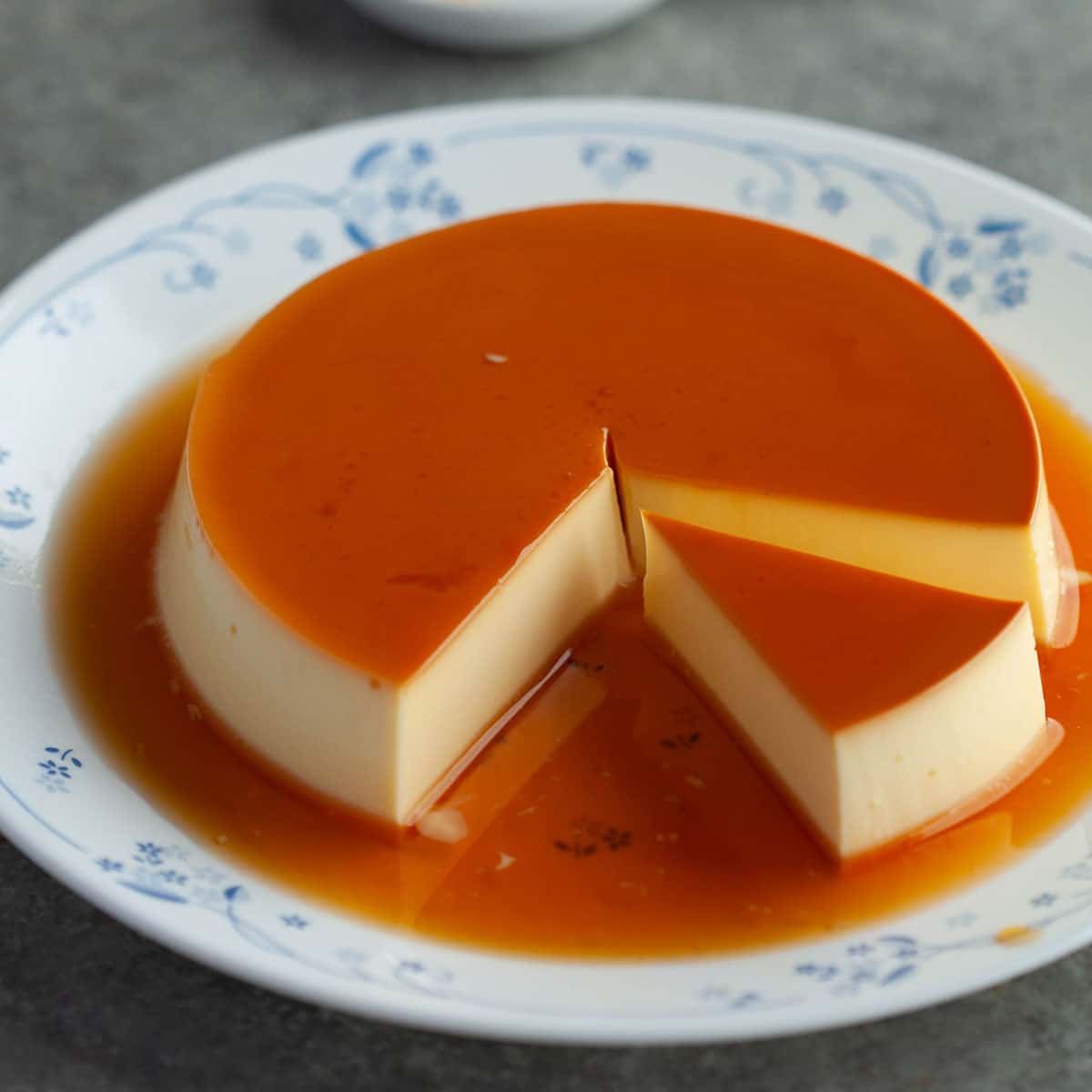 Before storing flan in the fridge, you need to allow it to cool down to room temperature. You can keep it on a plate still in its flan ring, or you can remove it from the pan onto a serving plate and refrigerate.