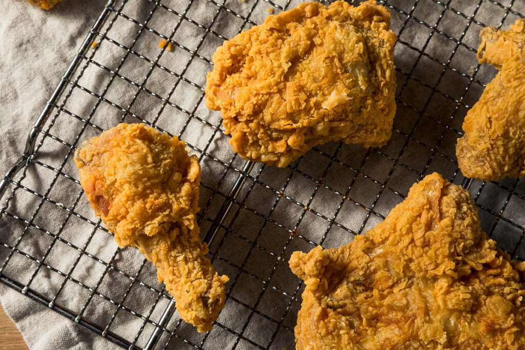 Place their crispy fried foods on a cooling rack above a baking sheet in a low oven and keep adding freshly fried goodies as they come out of the frier, always making sure they are spaced well apart for that all-important air circulation.