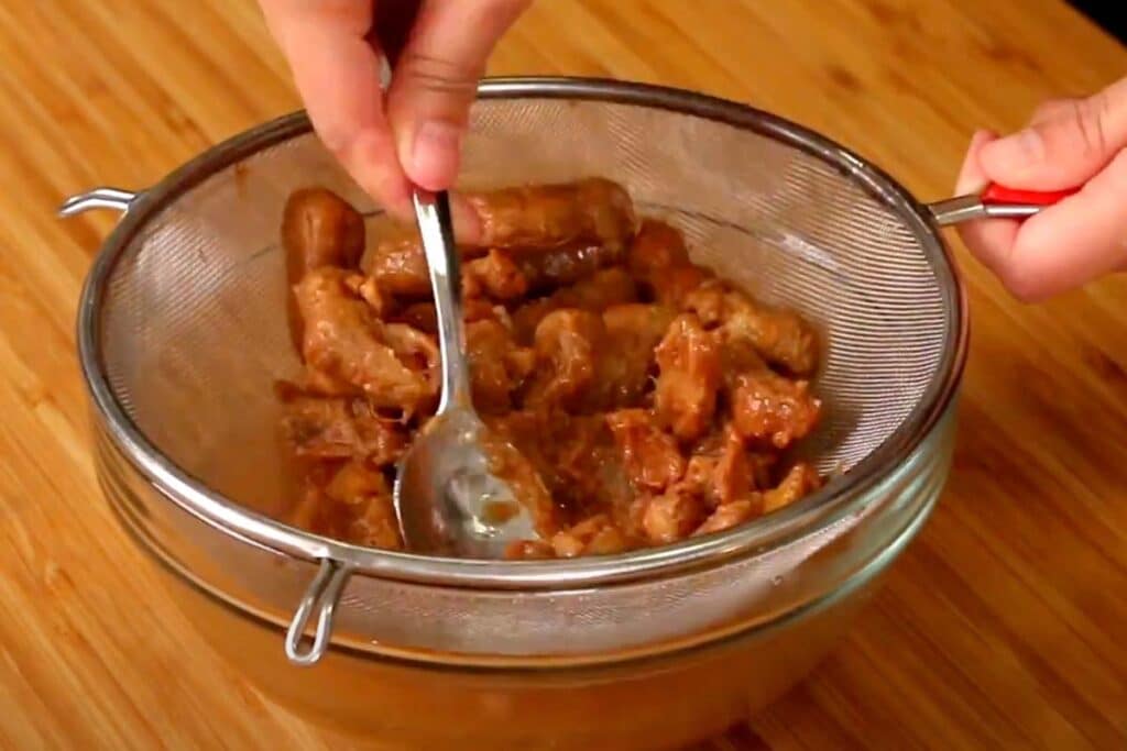 Using your fingers, squeeze as much juice as you can from the pulp. Pass the mixture through a sieve.